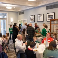 Families gathered around a table talking